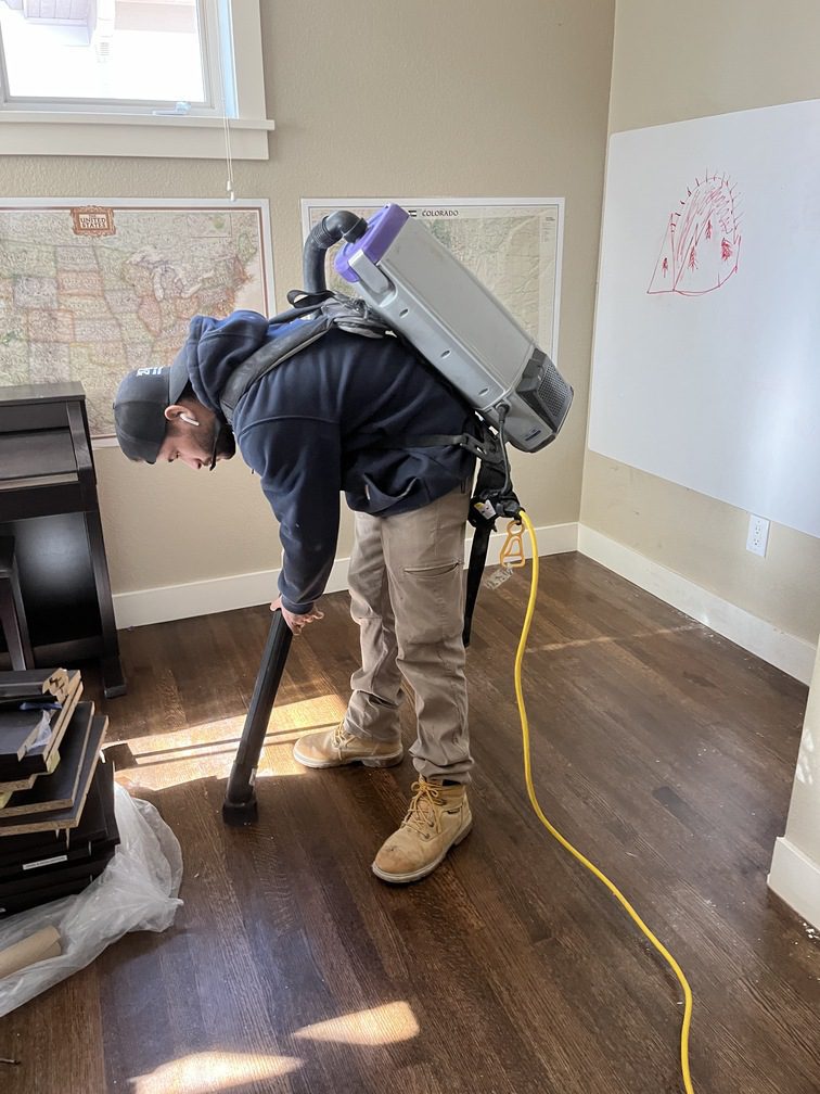 vacuuming dust and debris in a restored home office
