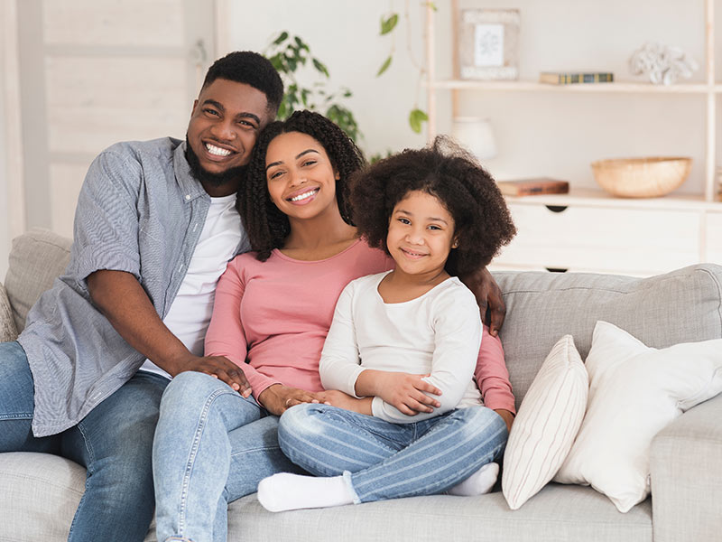 parents and child in their restored home