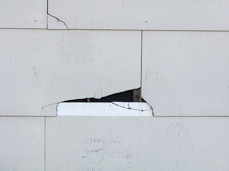 Asbestos siding cracking on home