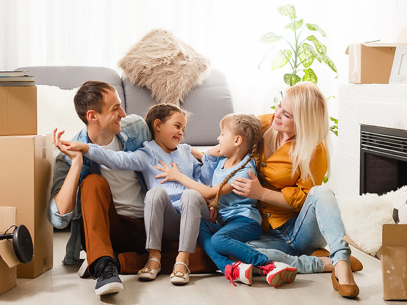 happy family celebrating moving back into their home after damage