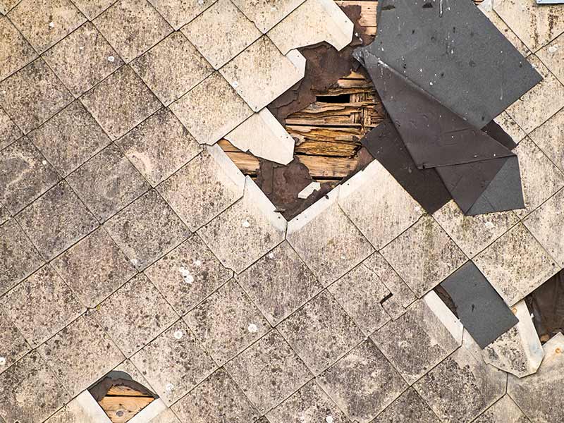 Old damaged roof of asbestos shingles