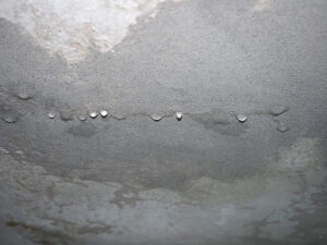 dampness moisture on ceiling with drops of water infiltration