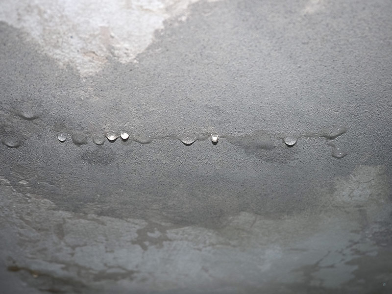 dampness moisture on ceiling with drops of water infiltration