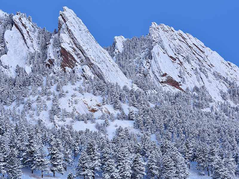 Winter landscape of the snow flocked Flatirons at dawn, Rocky Mountains, Boulder, Colorado