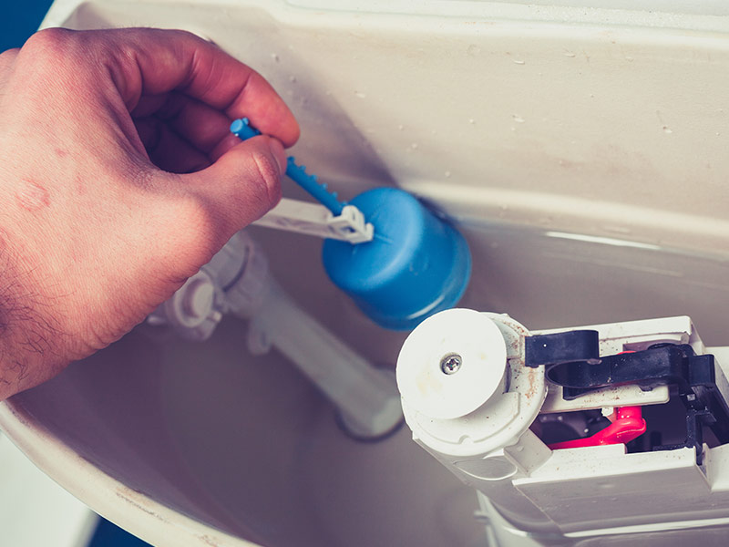 Hand fixing toilet by pulling up the flow