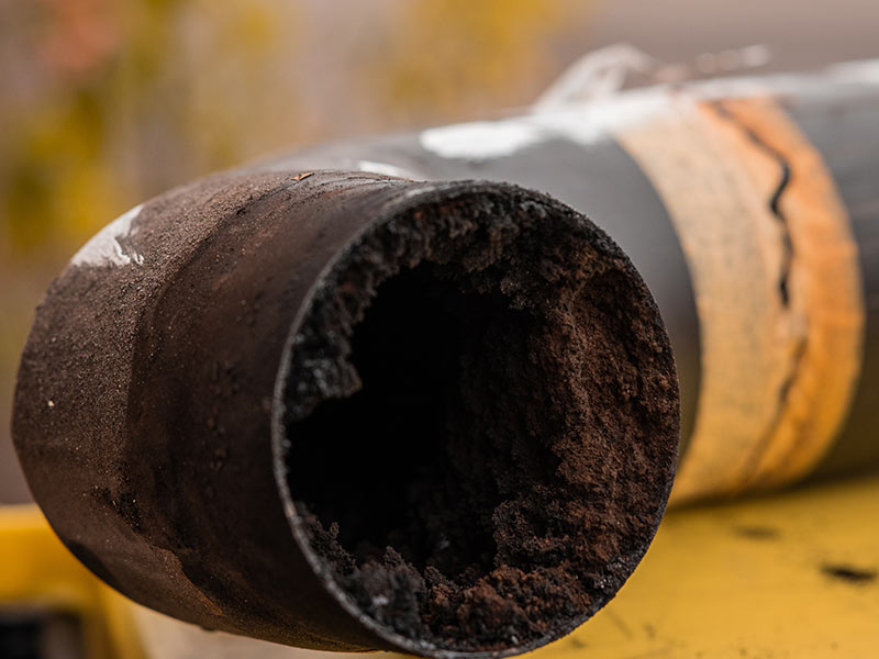 Residue or thick layer of soot after a poor combustion in a fireplace, layered on the inner part of a chimney pipe or smokestack