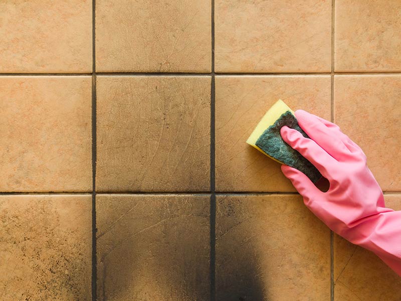 home owner trying to remove soot stains off tile wall