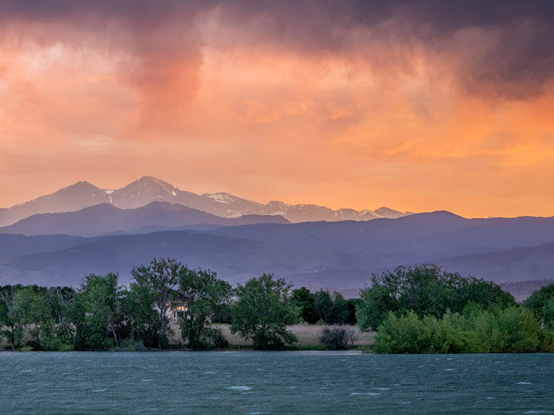 stormy sunset with high wind over Longs Peak and Front Range of Rocky Mountains