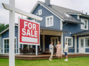 realtor speaking with home buyers outside house
