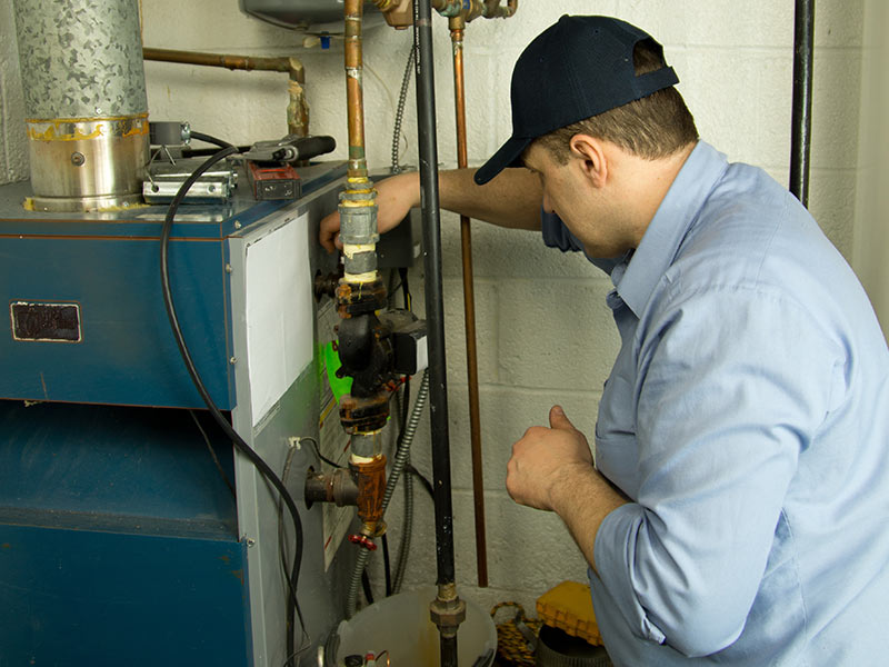 plumber inspecting furnace