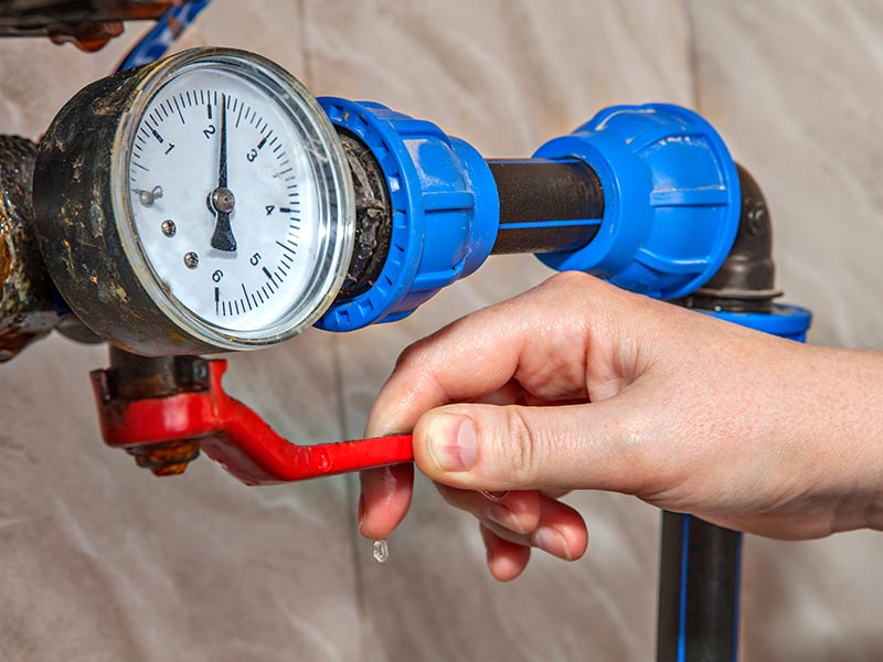 hand shutting off main water valve